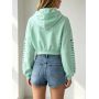 green hoodie with pink skull hand print